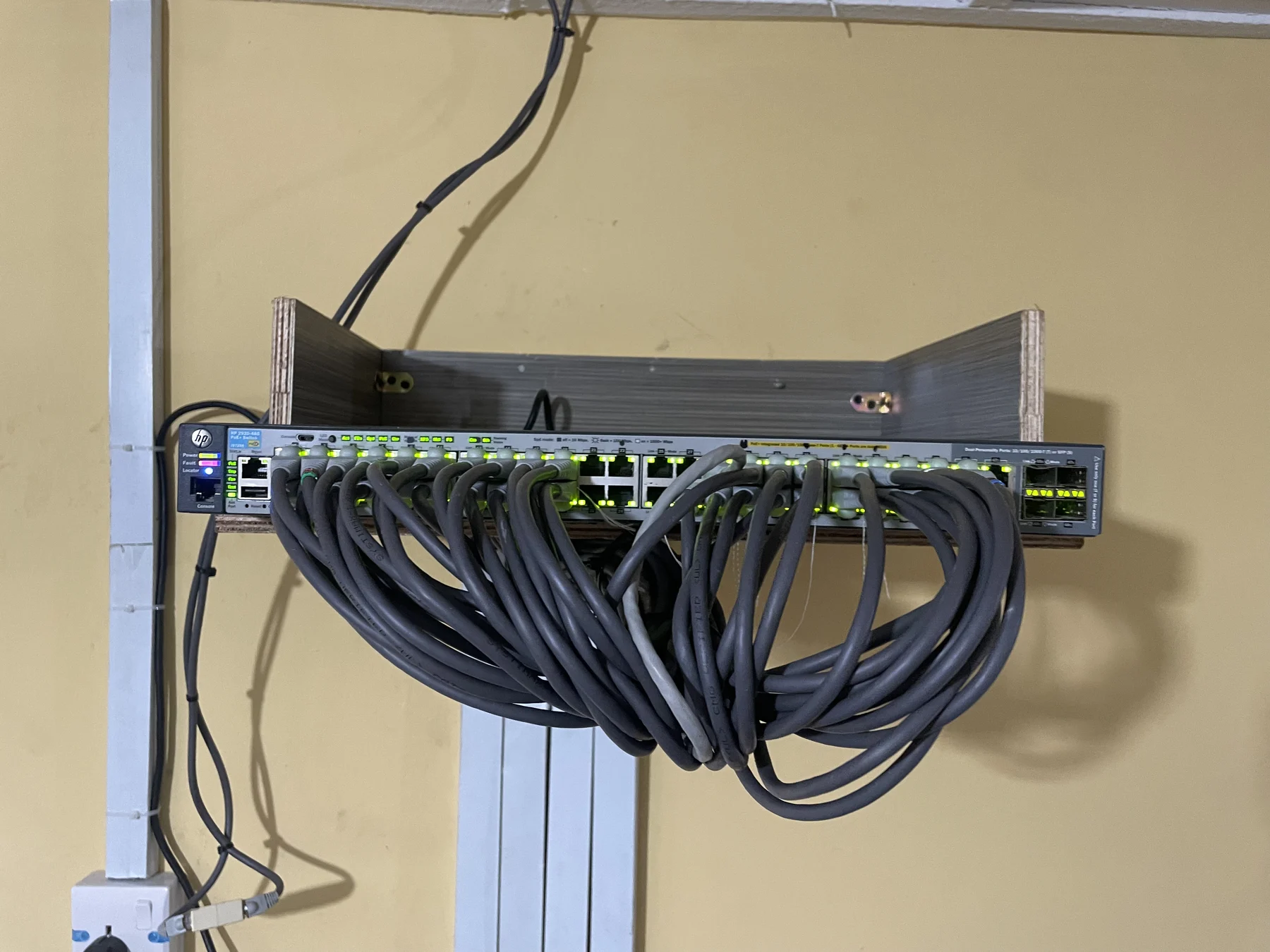 A school network switch with connected Ethernet cabling and active network ports.